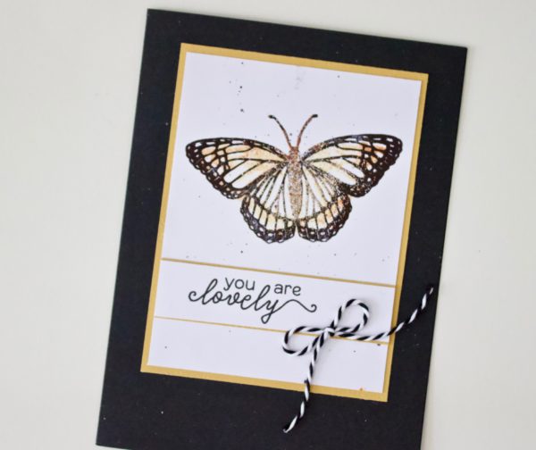 Create a layered, embossed butterfly motif with the Hero Arts Monarch Butterfly and Sand embossing powder. 